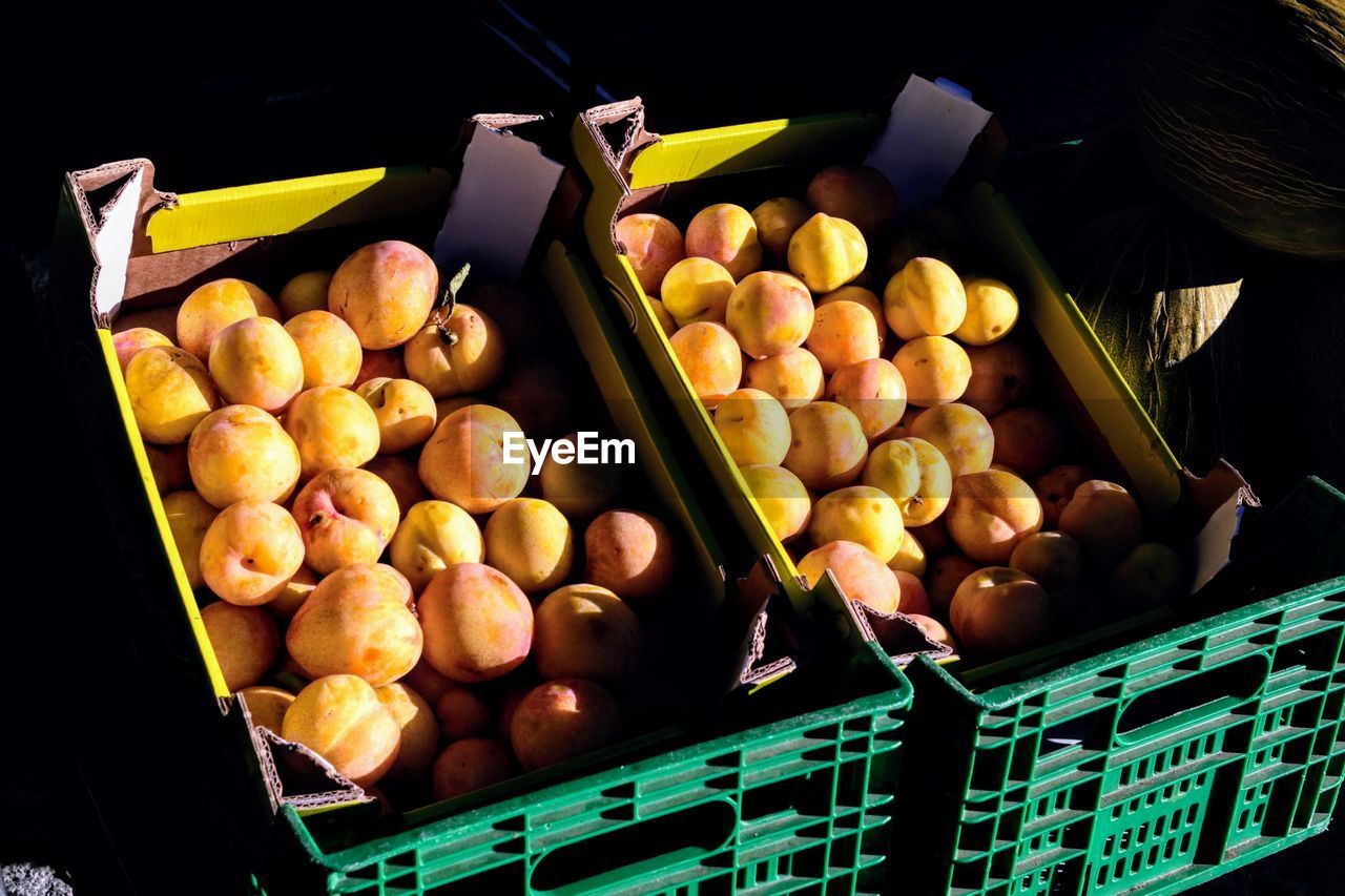 High angle view of fruits in crate at market stall