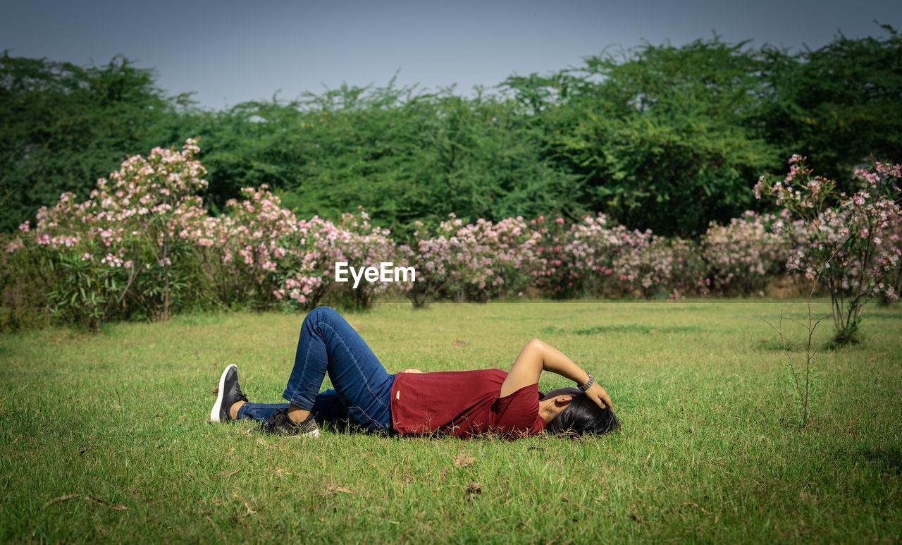 MAN LYING DOWN ON FIELD