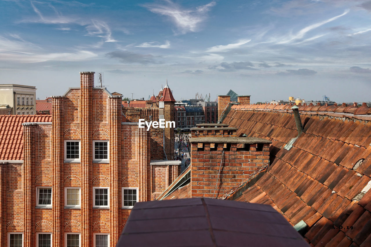 High angle view of buildings against cloudy sky