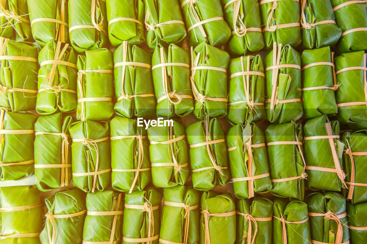 Full frame shot of food wrapped in banana leaves for sale at market stall