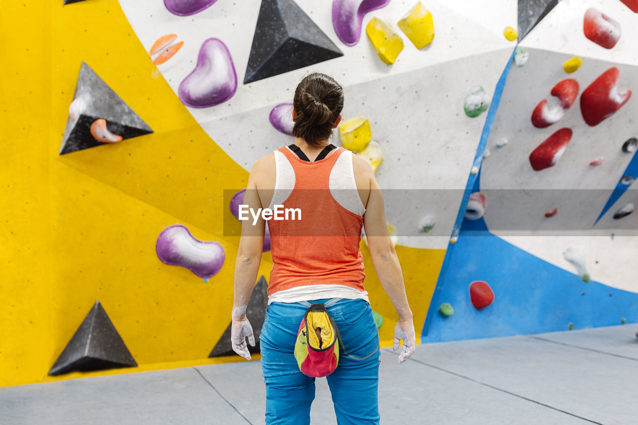 Woman climbing on wall