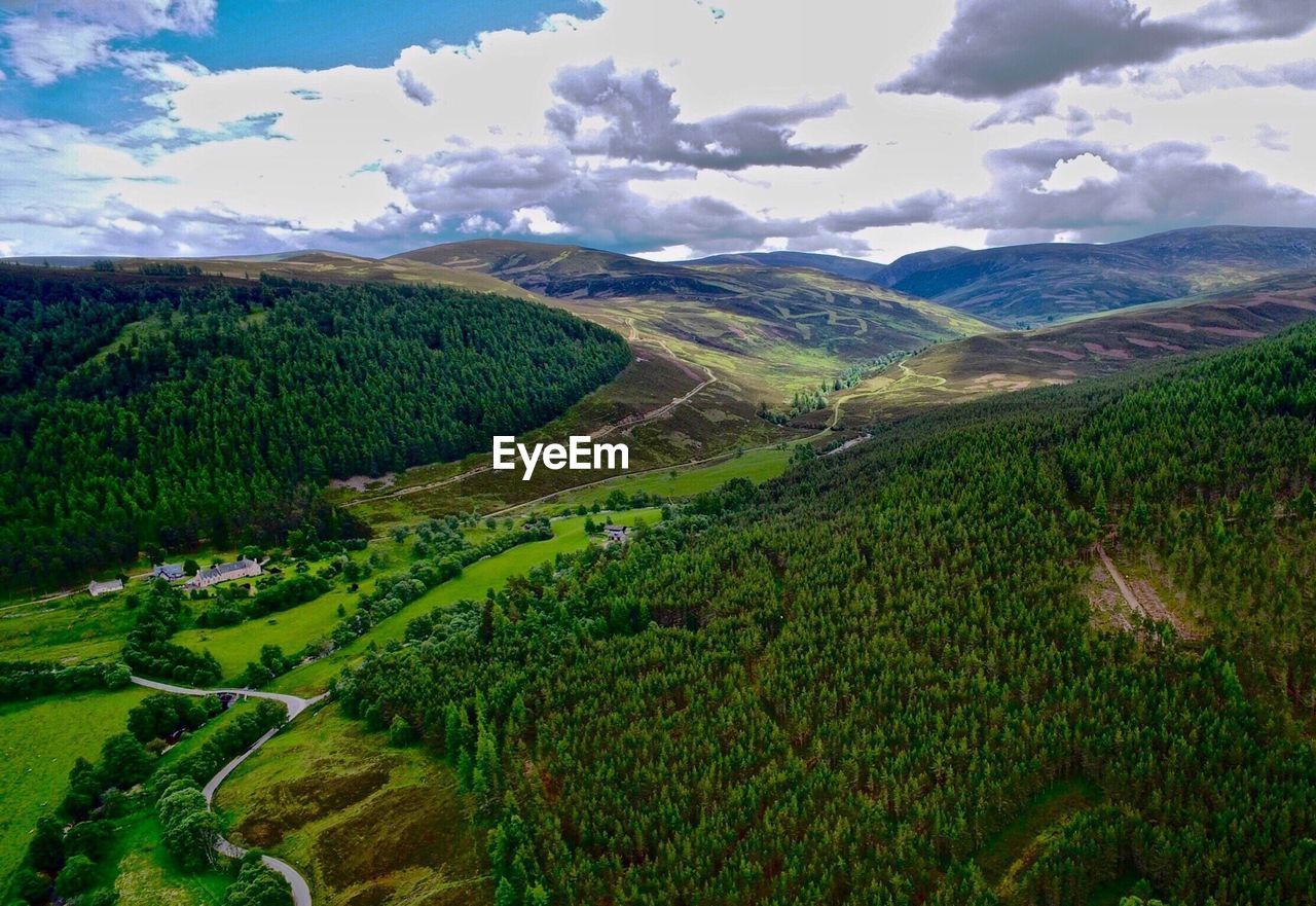 Scenic view of valley and mountains against sky