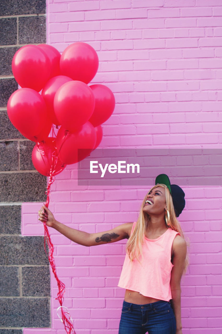 Woman with red balloons