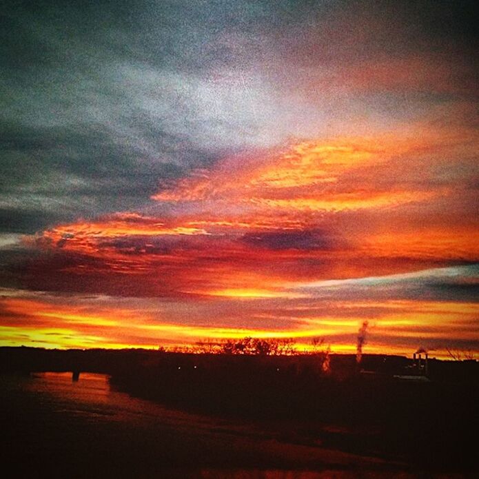 SCENIC VIEW OF DRAMATIC SKY OVER SILHOUETTE LANDSCAPE DURING SUNSET