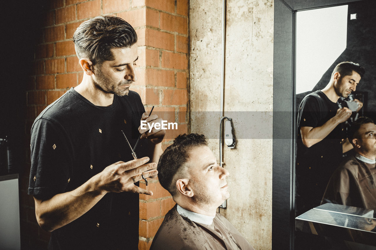 Hairdresser and beautician working in her hair salon