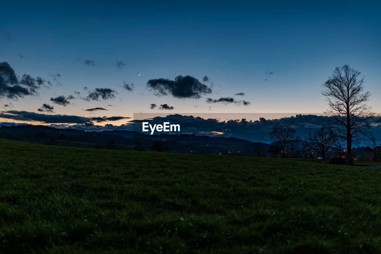 Scenic view of field against sky during sunset