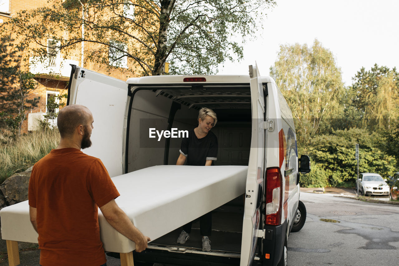 Couple putting bed into van