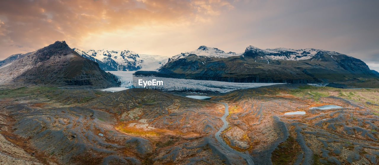 Beautiful glaciers flow through the mountains in iceland.