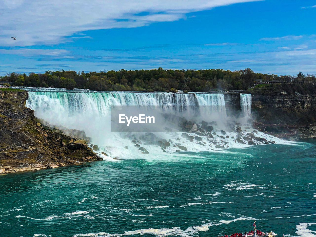 Scenic view of waterfall against sky