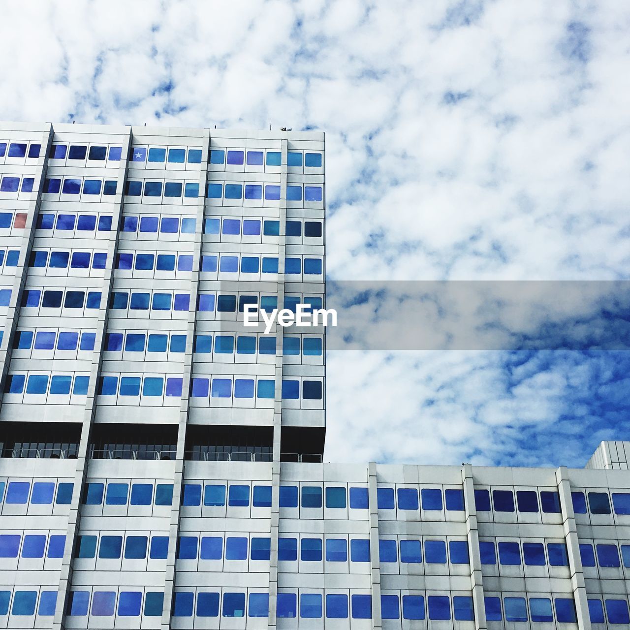 LOW ANGLE VIEW OF OFFICE BUILDING AGAINST SKY