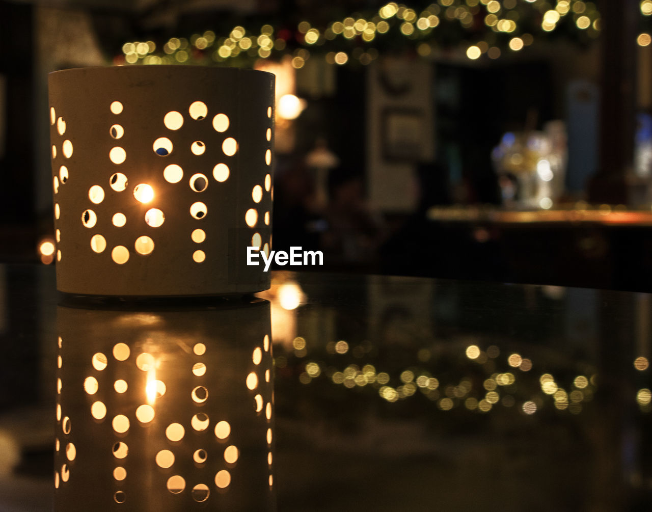 Close-up of illuminated lantern on table in restaurant