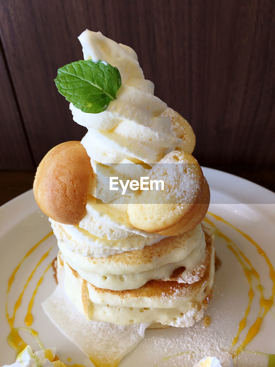 CLOSE-UP OF ICE CREAM IN PLATE WITH BREAD AND SAUCE