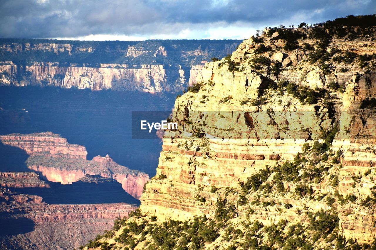 Scenic view of sea and mountain against sky