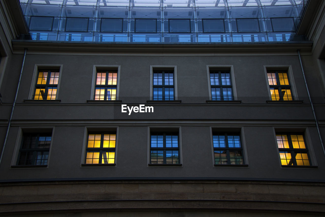 The building in berlin center, evening time, windows and night lights.