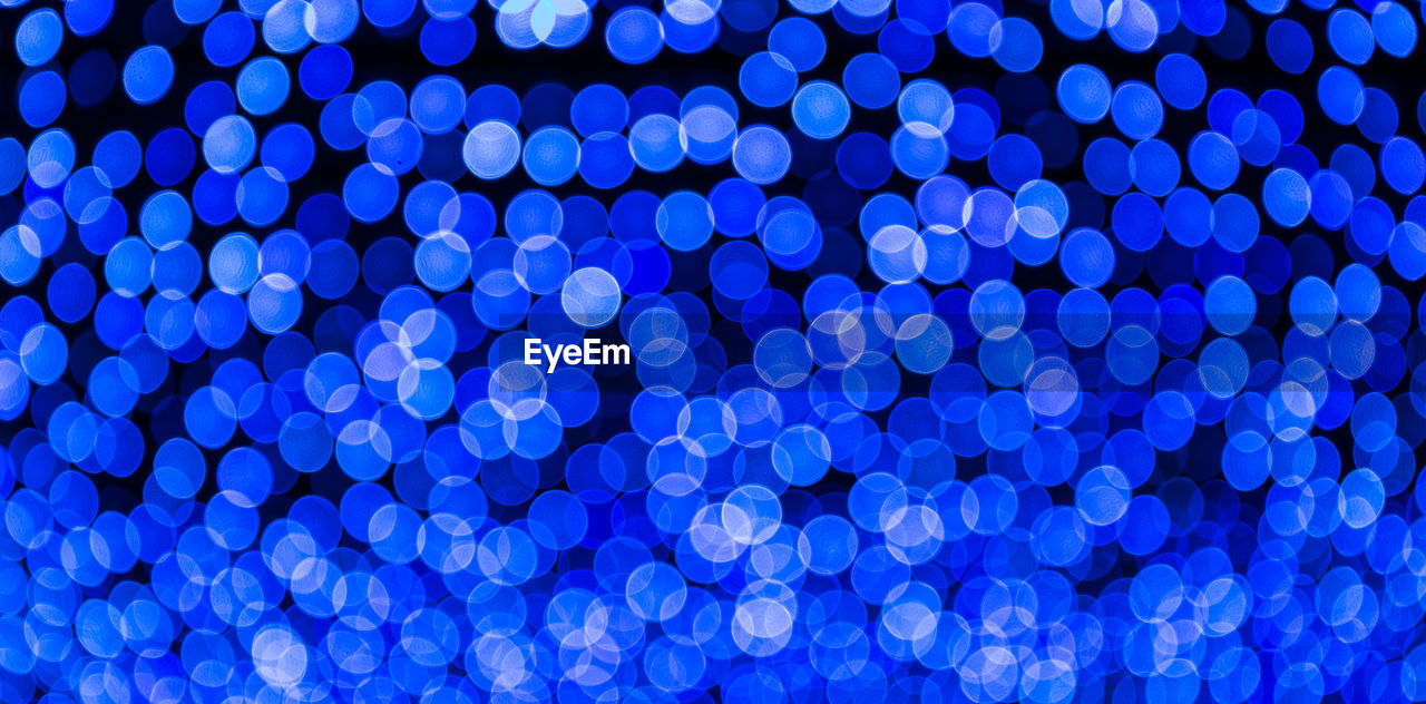 Defocused image of illuminated blue lights