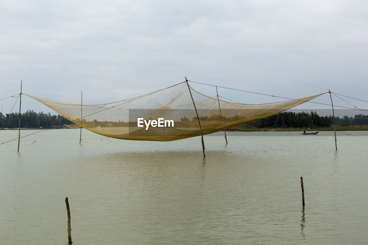 Large square-shaped fishing net over water off cam nam, hoi an, central vietnam