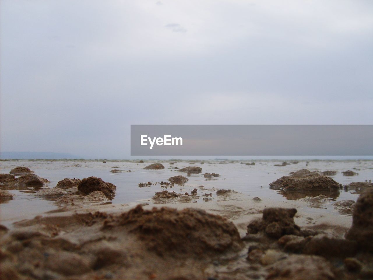 Rocks on beach against sky