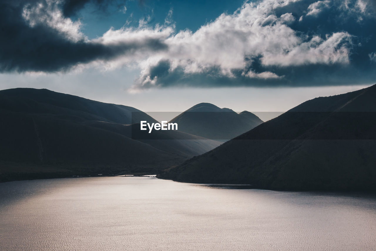 Scenic view of mountains against blue sky