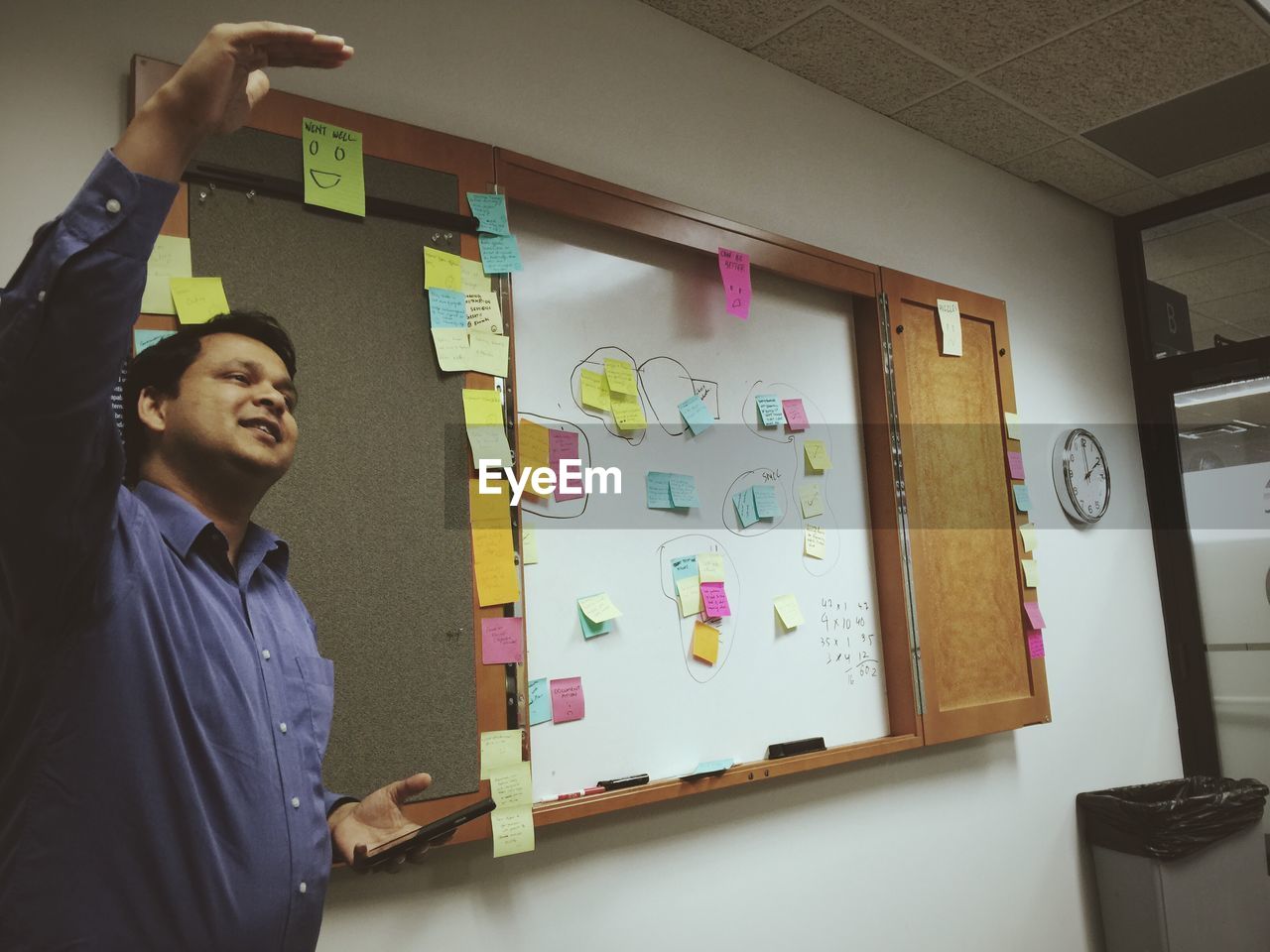 Young man giving presentation in board room