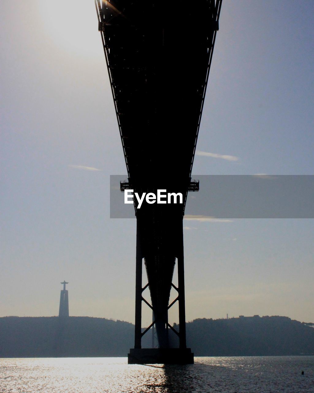 Low angle view of bridge over sea against sky