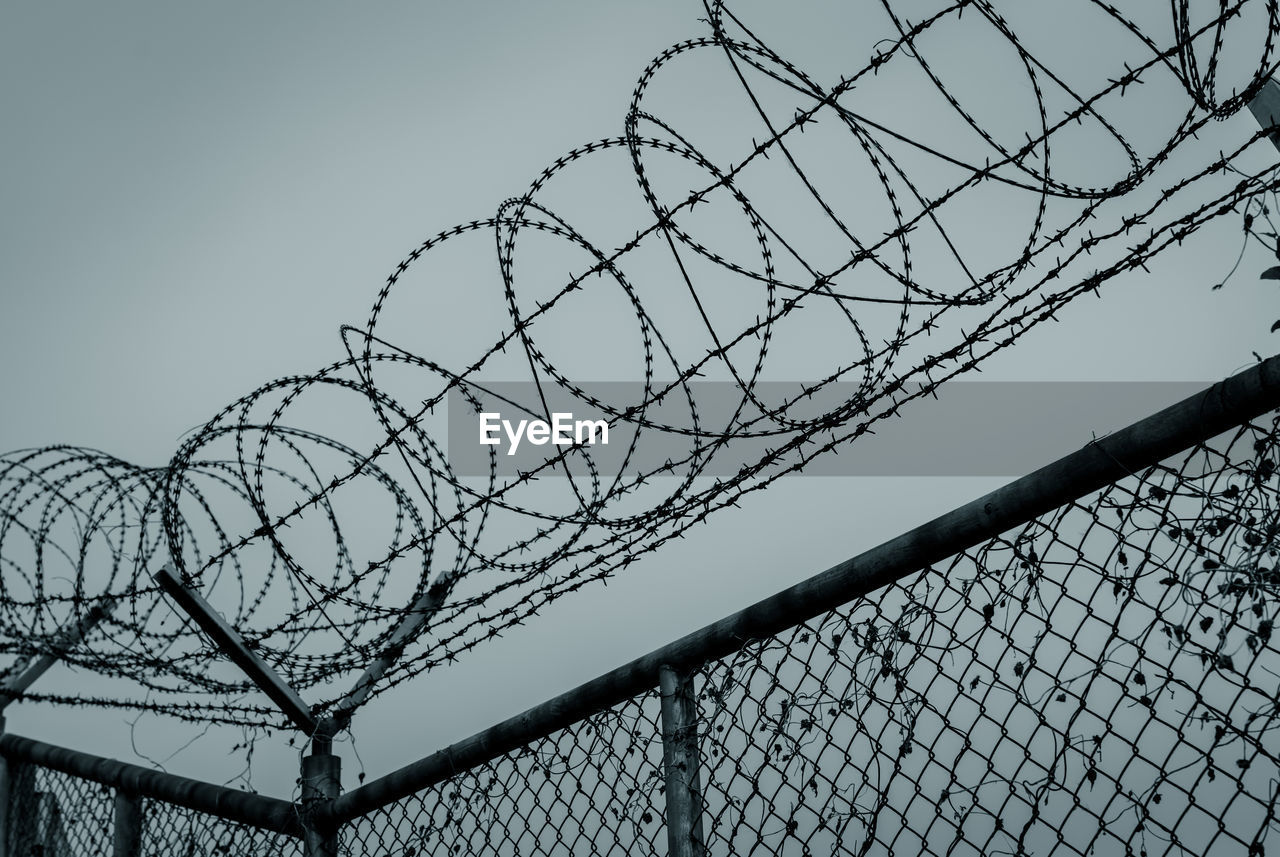 Prison security fence. barbed wire security fence. razor wire jail fence. barrier border. 