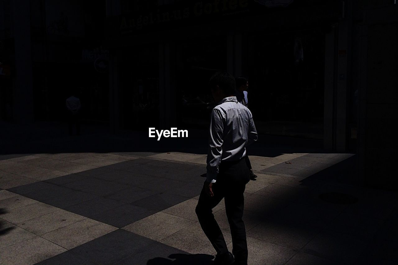 Man walking in street at night