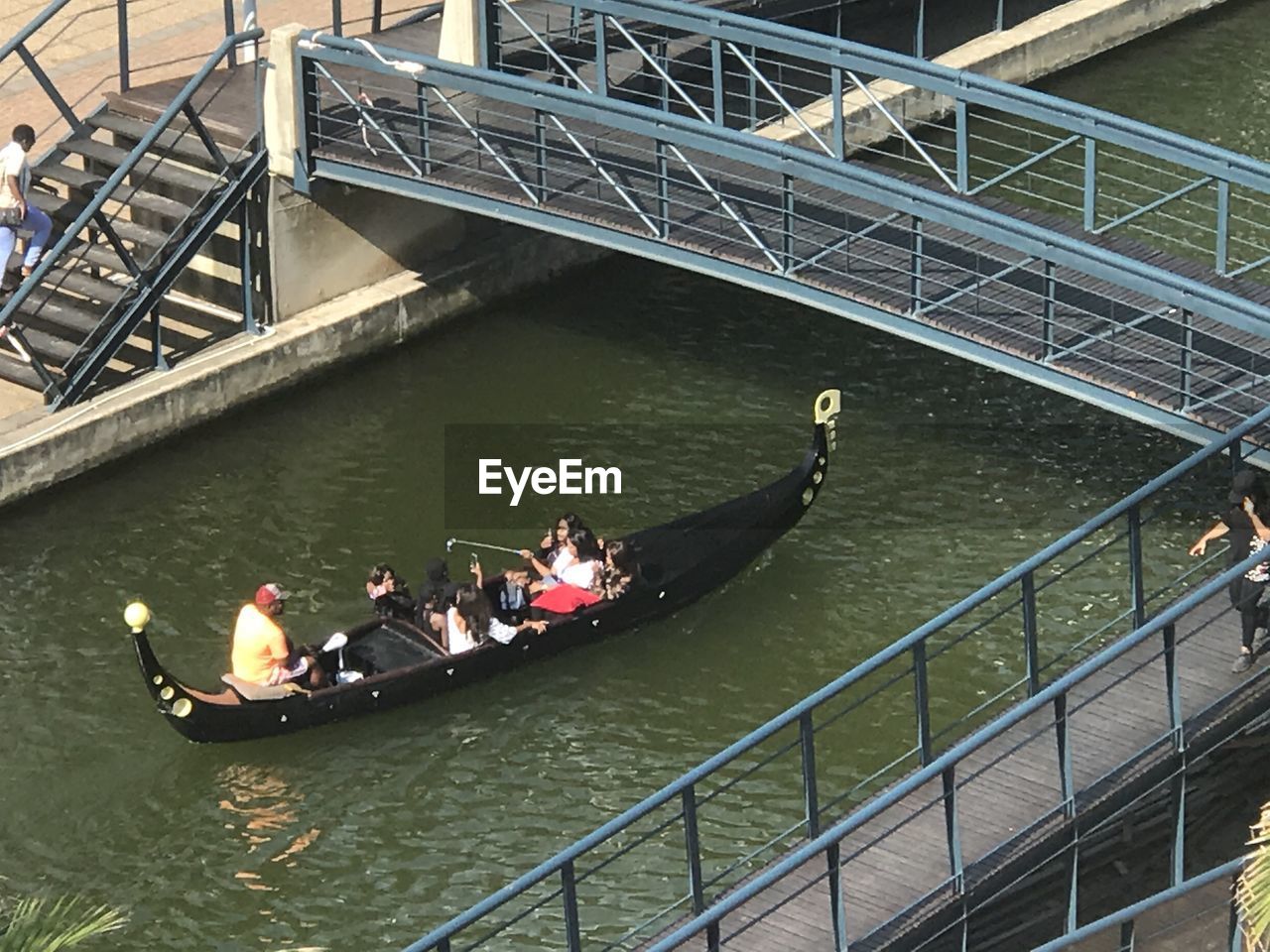 HIGH ANGLE VIEW OF PEOPLE ON BRIDGE AT RIVER