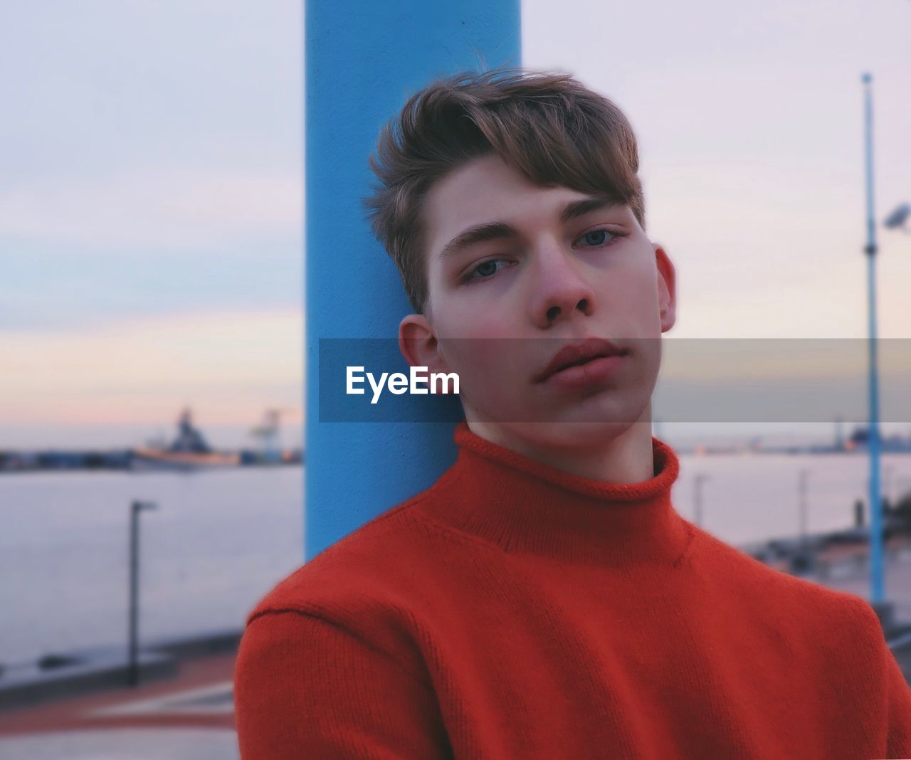 Portrait of young man against sky during sunset