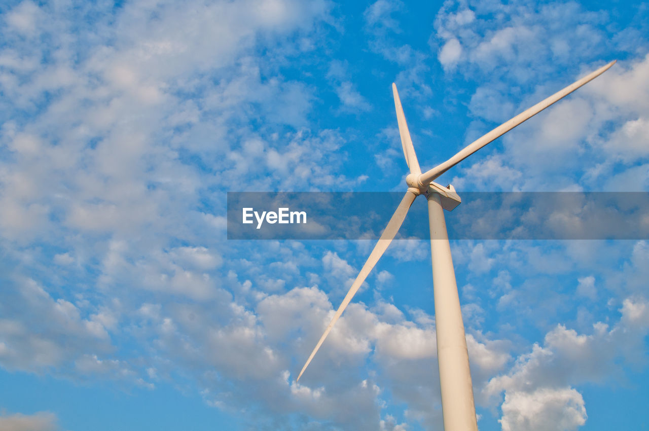 Low angle view of windmill against sky