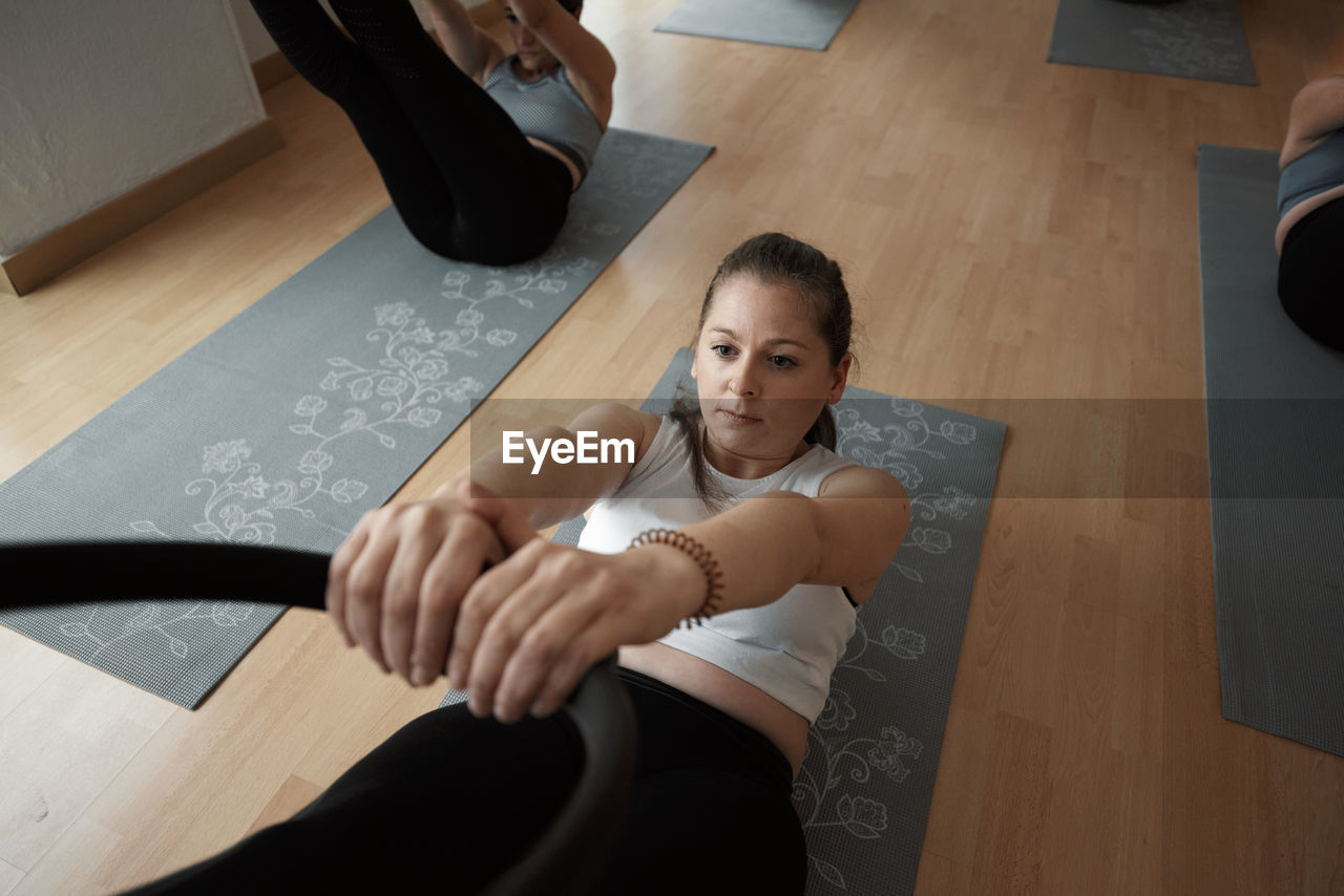 Group of women practicing pilates exercises in class