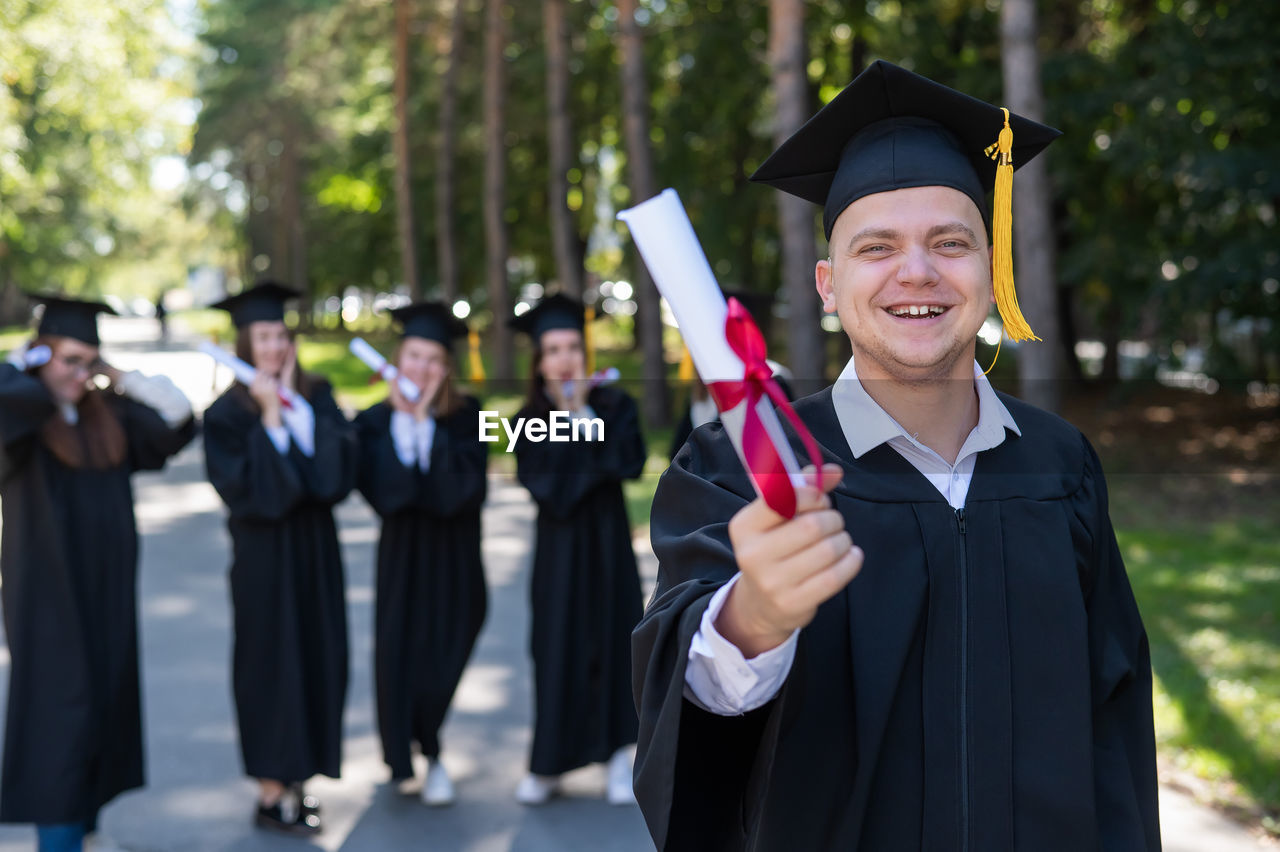 rear view of man wearing graduation gown