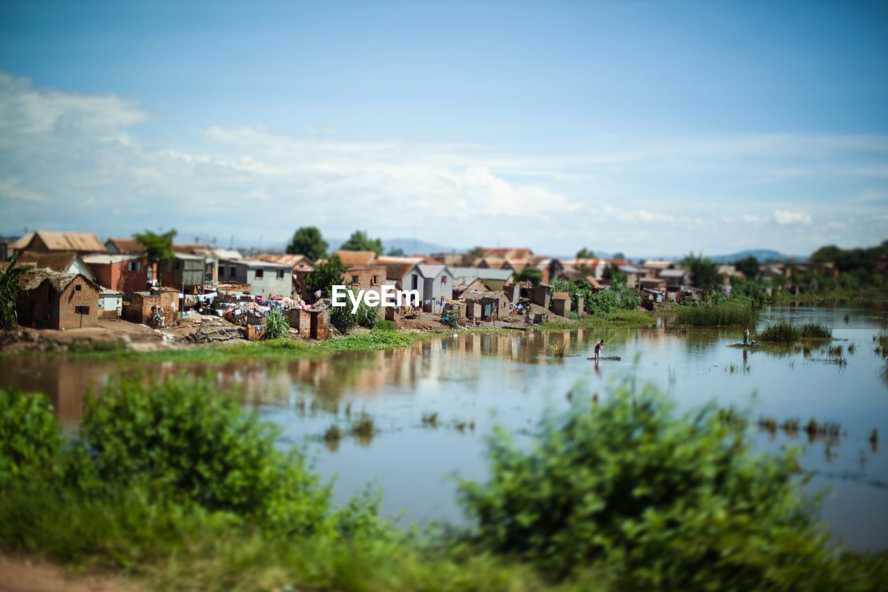 HOUSES BY TOWN AGAINST SKY IN CITY