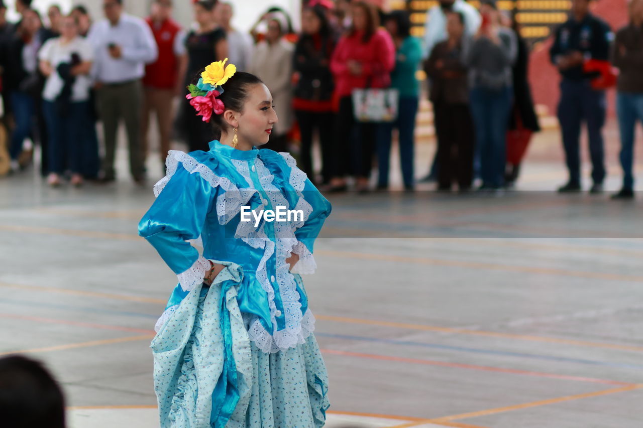 REAR VIEW OF PEOPLE LOOKING AT VIEW OF FLOWER