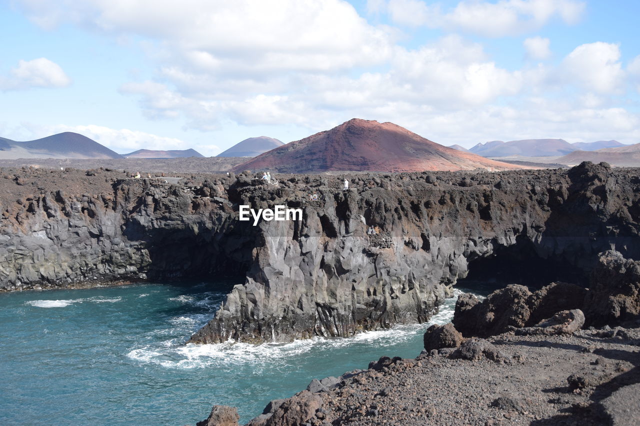 Panoramic view of sea and mountains against sky