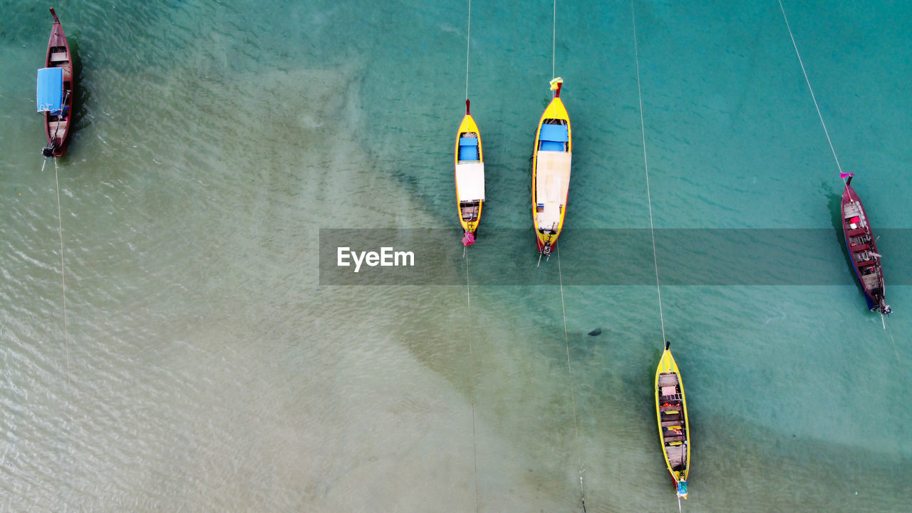 HIGH ANGLE VIEW OF PEOPLE IN BOAT ON SEA