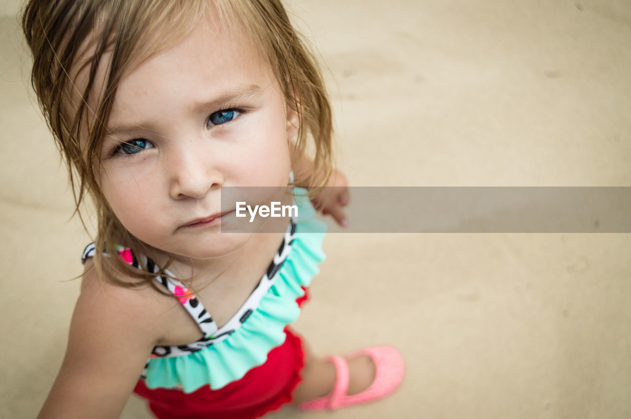 Close-up portrait of cute girl at beach