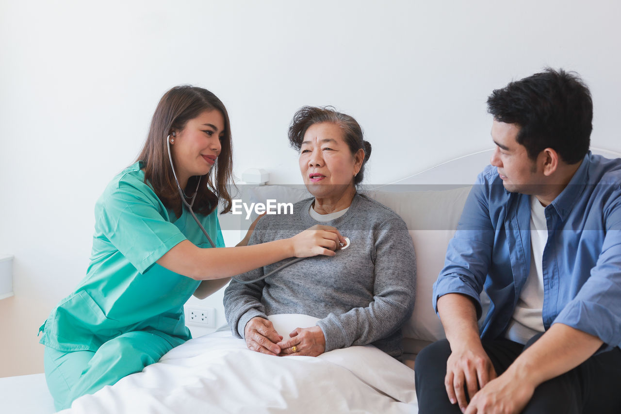 YOUNG WOMEN SITTING IN THE WALL