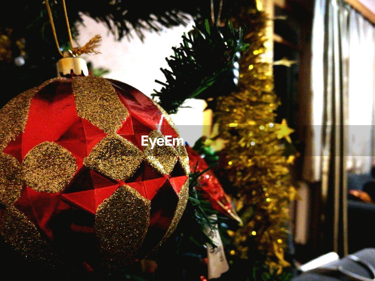 CLOSE-UP OF CHRISTMAS TREE AT NIGHT HANGING FROM WALL