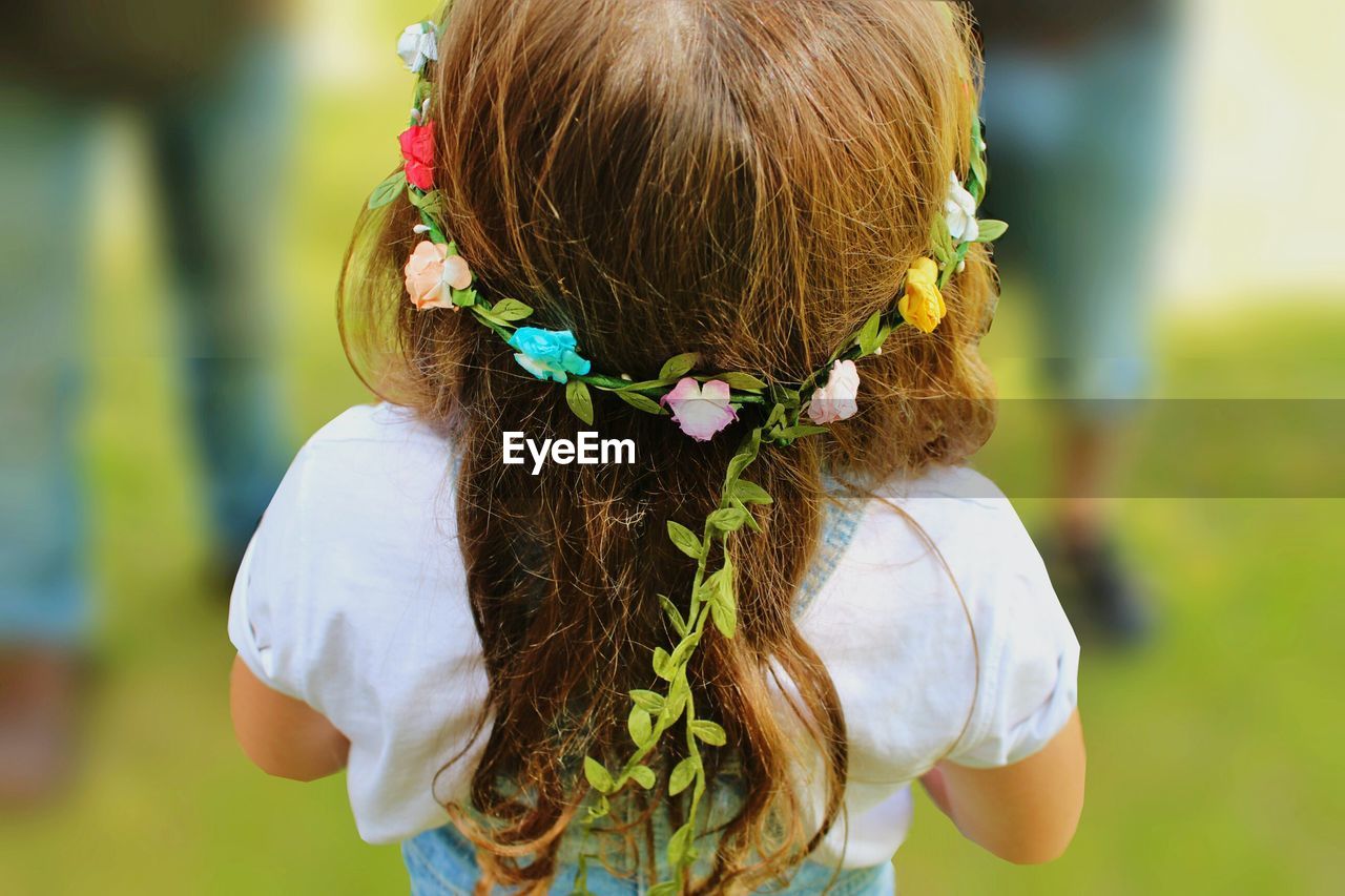 Rear view of flower garland in girl's hair