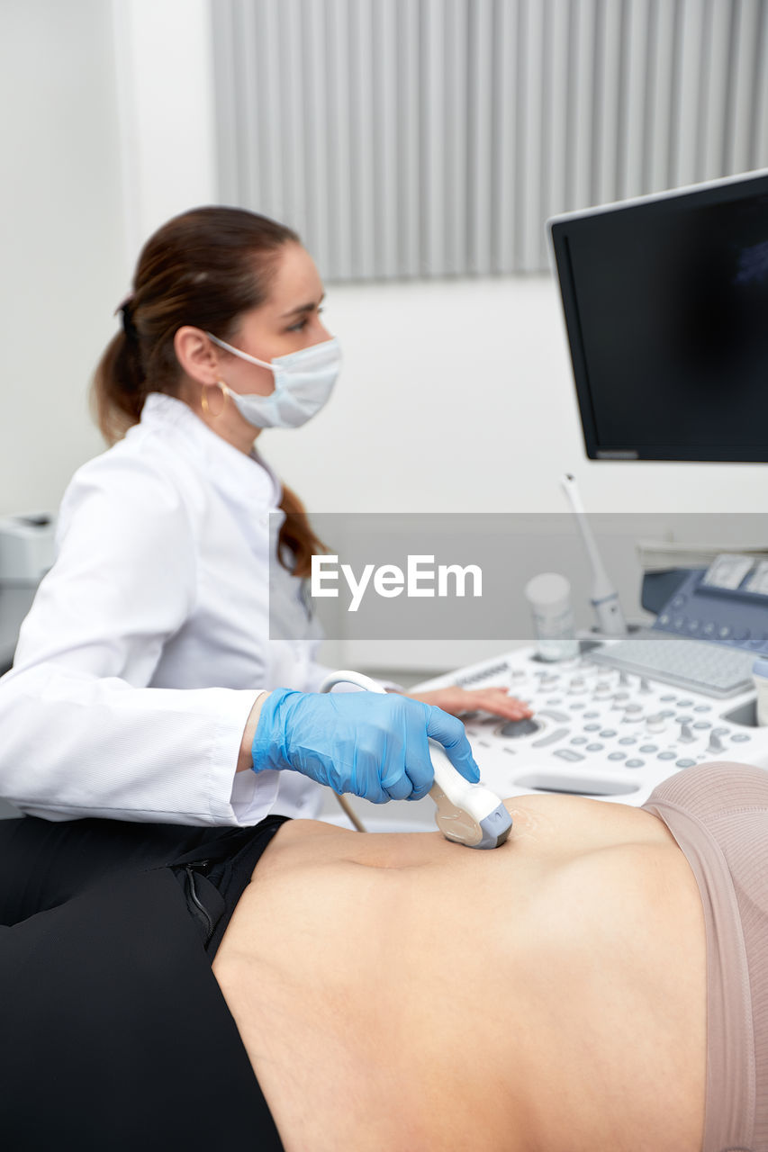 young woman using laptop at clinic