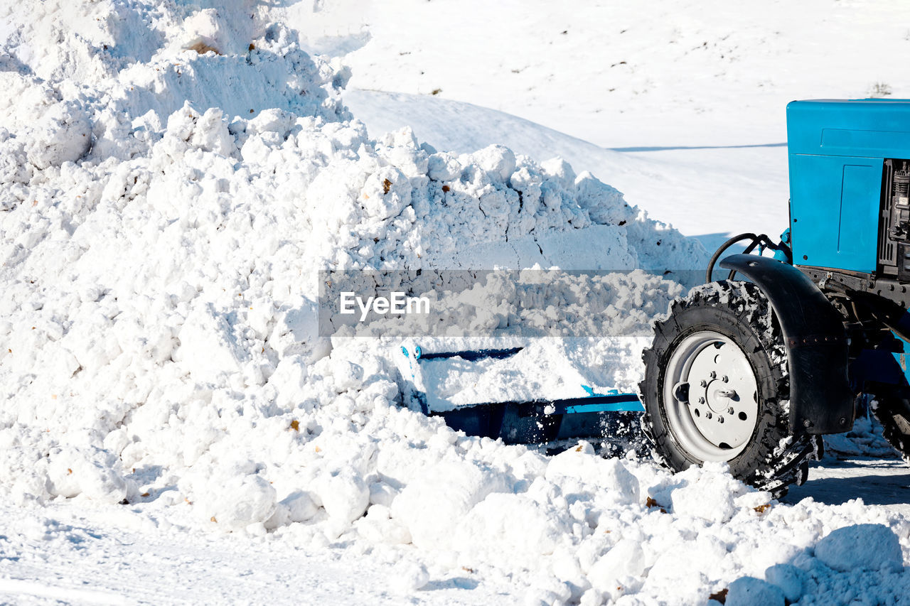 SNOW COVERED LAND BY ROAD