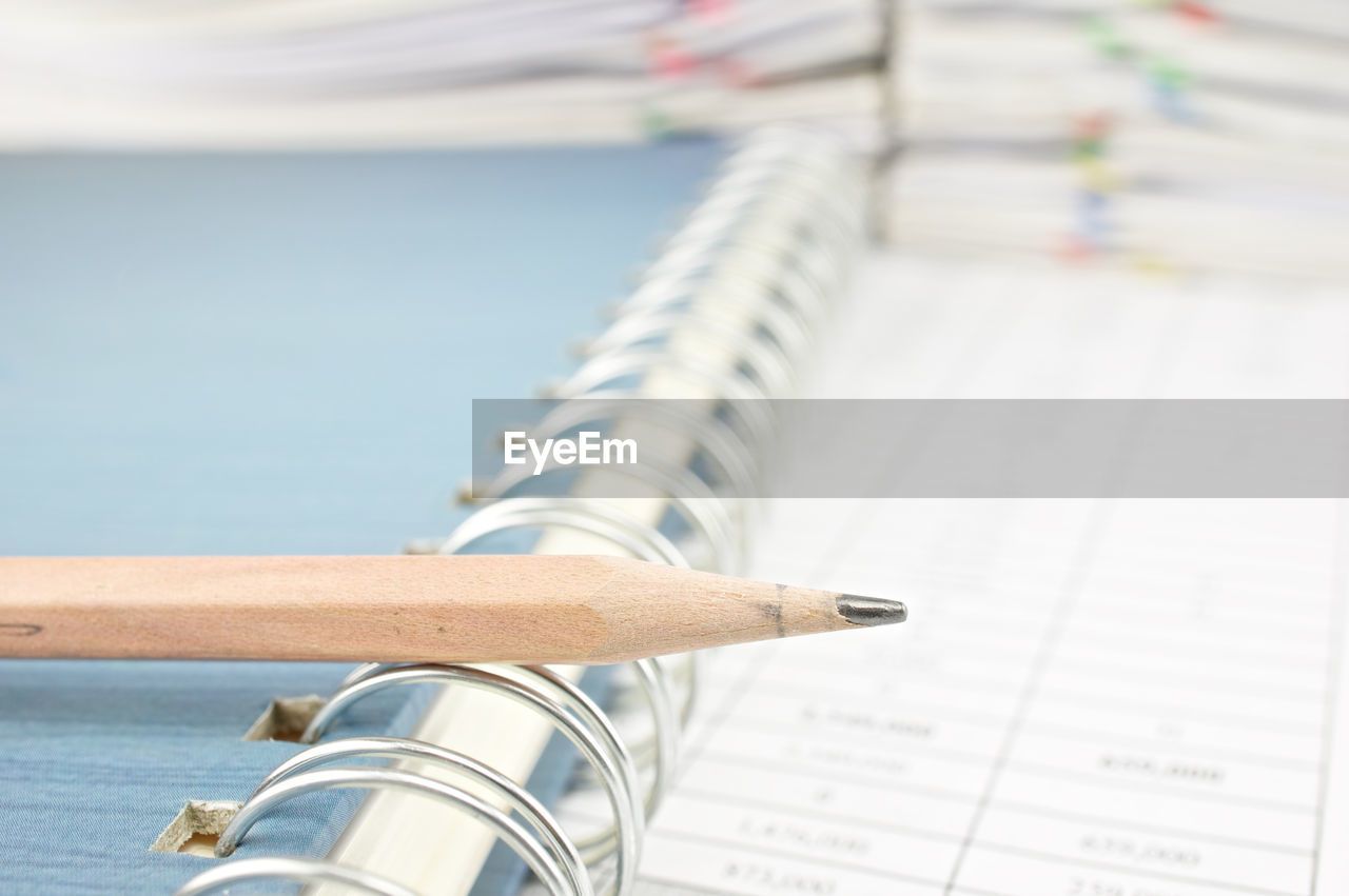 Close-up of pencil on book in office