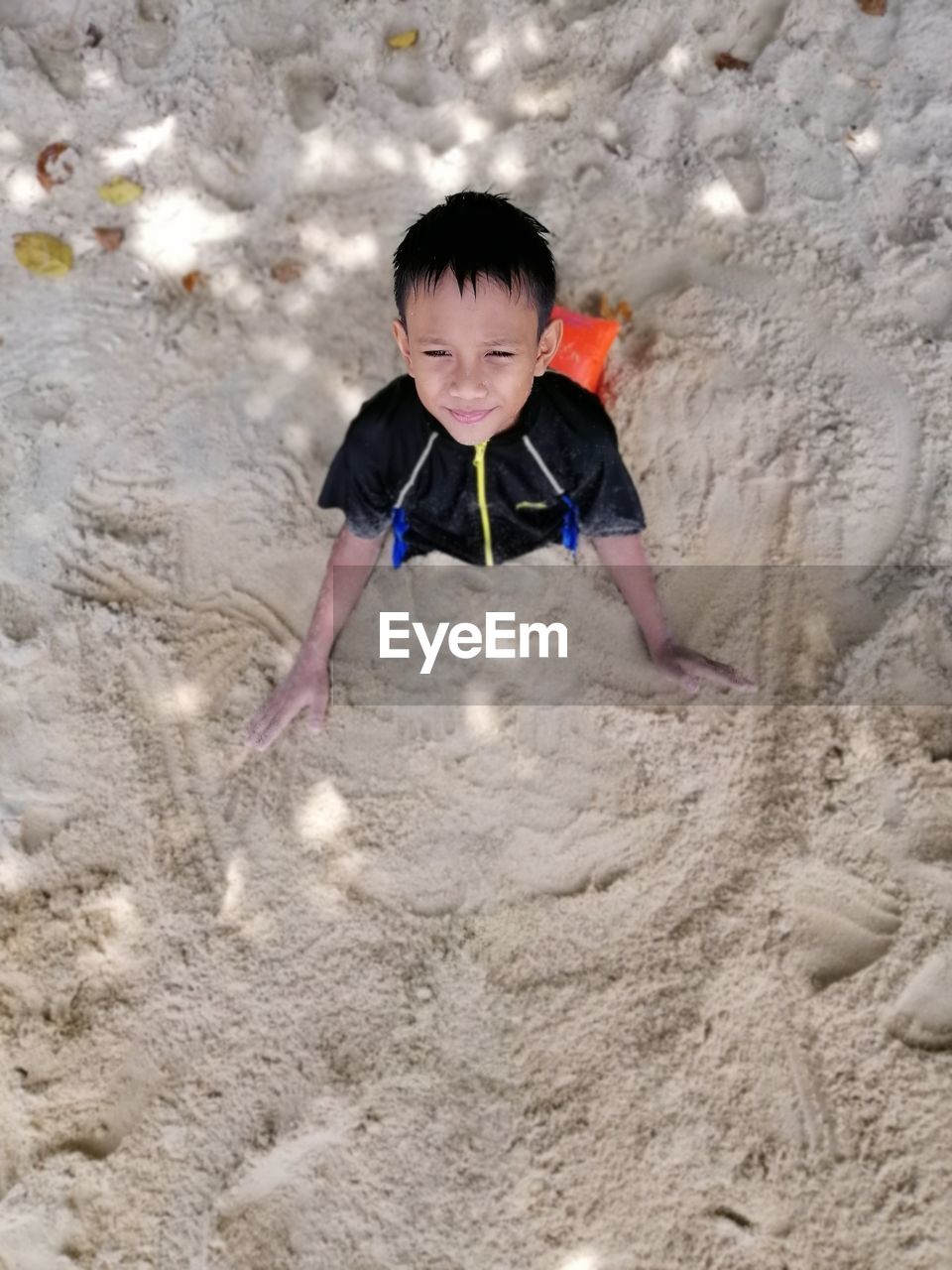 HIGH ANGLE VIEW PORTRAIT OF BOY PLAYING IN SAND