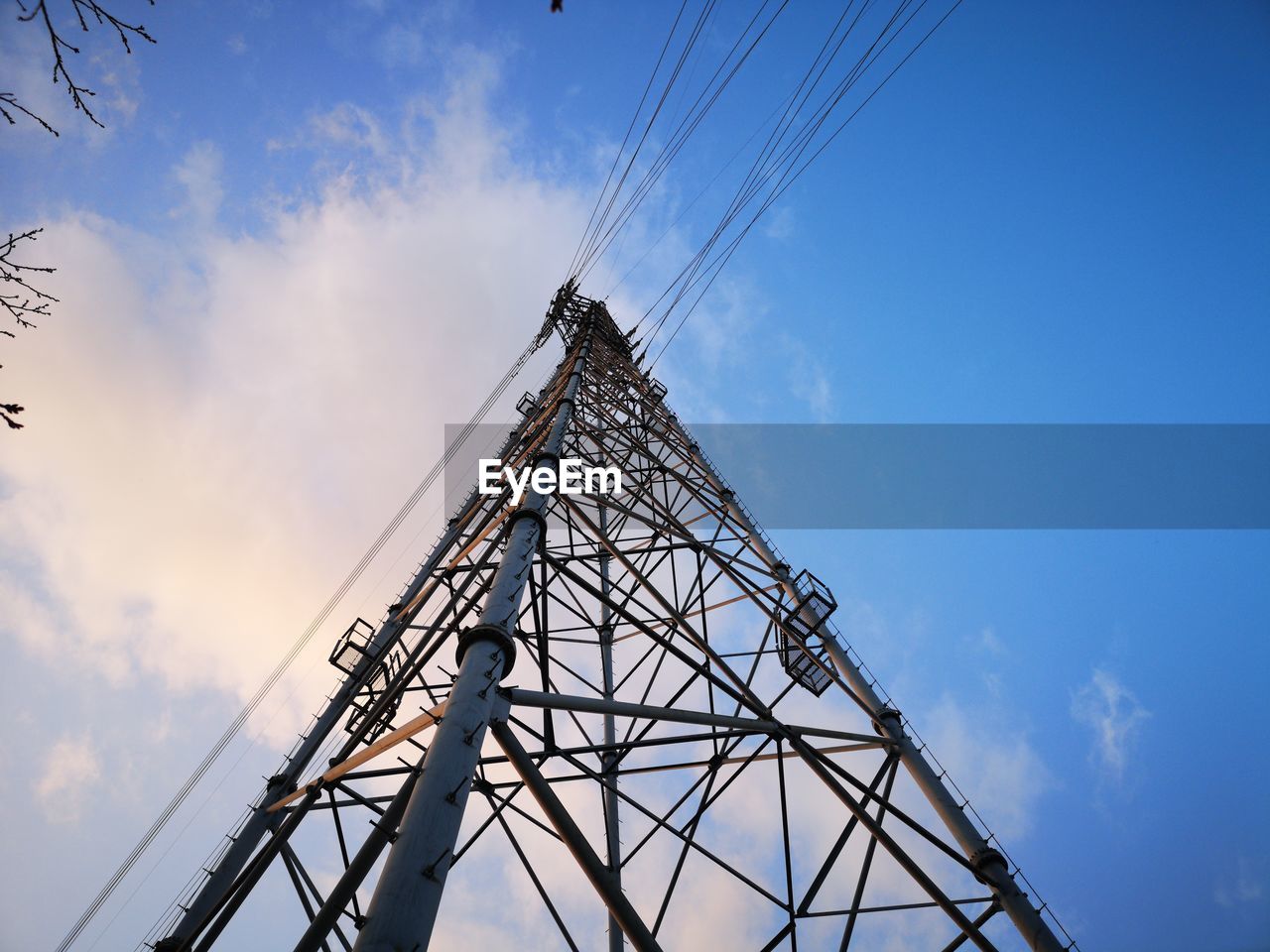 sky, technology, cloud, transmission tower, architecture, overhead power line, built structure, tower, power generation, cable, electricity, blue, electricity pylon, power supply, nature, industry, communication, electrical supply, steel, no people, metal, alloy, global communications, business finance and industry, silhouette, line, sunlight, outdoors, mast, low angle view, power line, looking up, warning sign, sign, electrical grid, business, high voltage sign