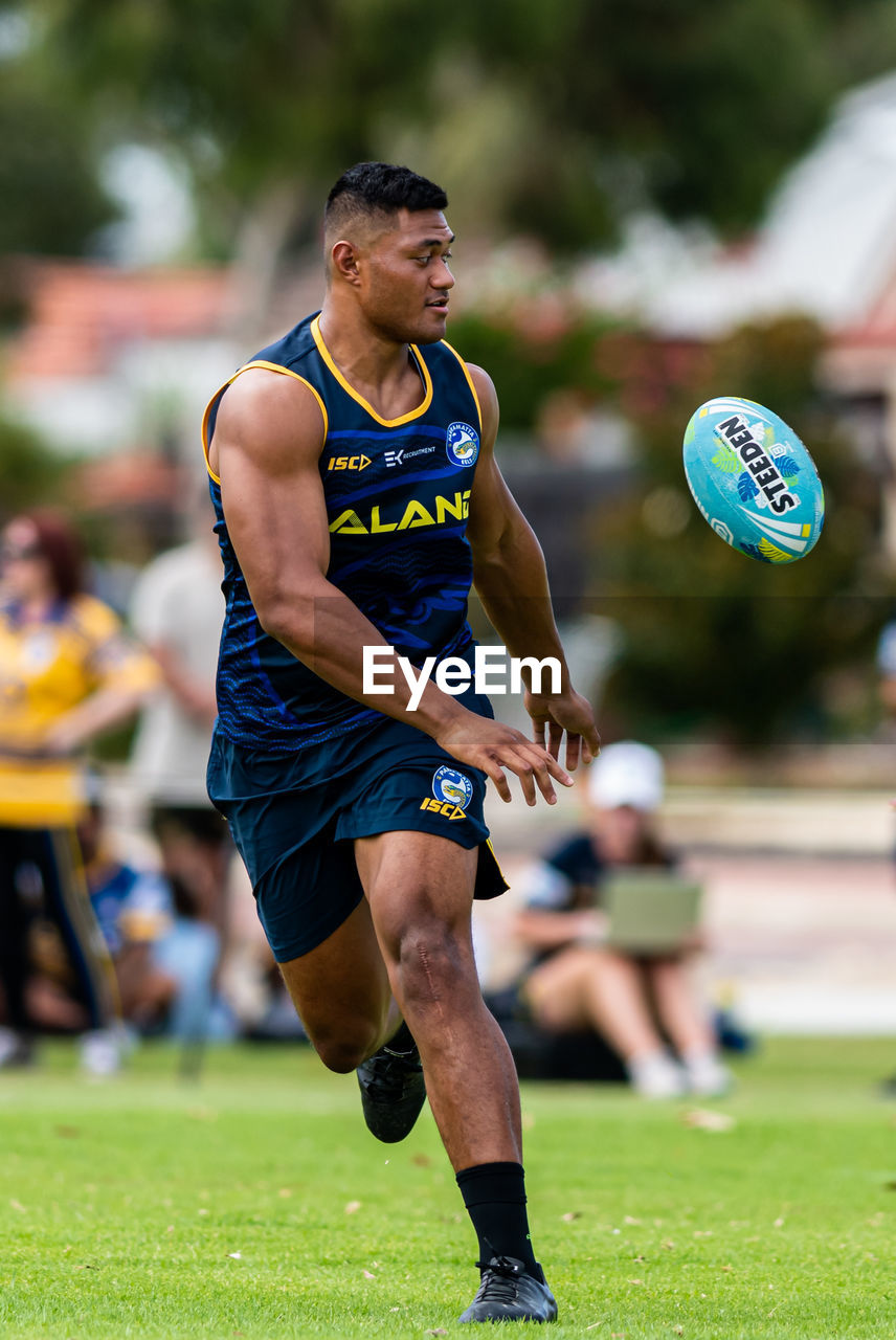 LOW SECTION OF MAN PLAYING WITH SOCCER BALL