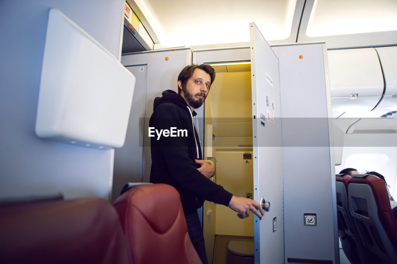 Man comes out of the toilet on an airplane