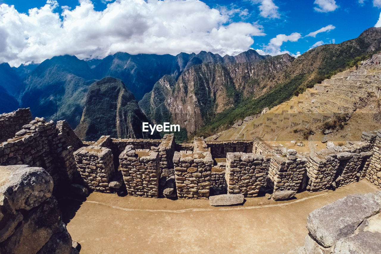 High angle view of structures at machu picchu against cloudy sky