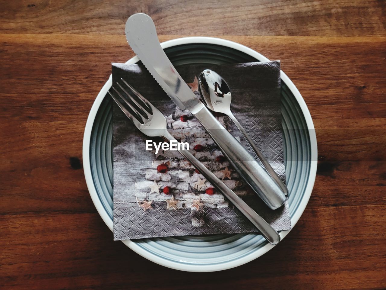 wood, table, kitchen utensil, fork, eating utensil, indoors, directly above, high angle view, plate, food and drink, no people, tableware, food, still life, iron, close-up, household equipment