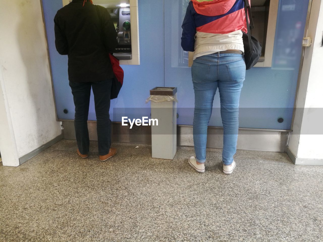 LOW SECTION OF PEOPLE STANDING IN CORRIDOR