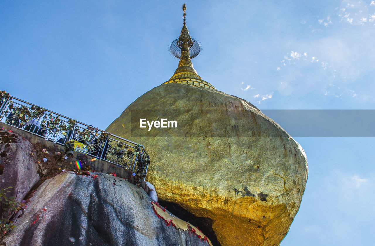 LOW ANGLE VIEW OF TEMPLE AGAINST BUILDINGS